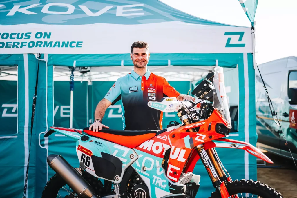 KOVE Rally rider with KOVE 450 Rally EX motorcycle at Dakar Rally paddock