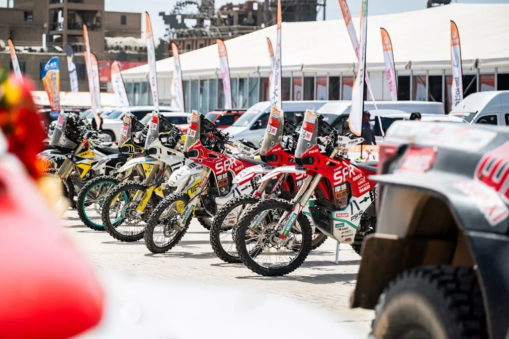 KOVE 450 Rally EX motorcycles lined up at Taklimakan Rally paddock