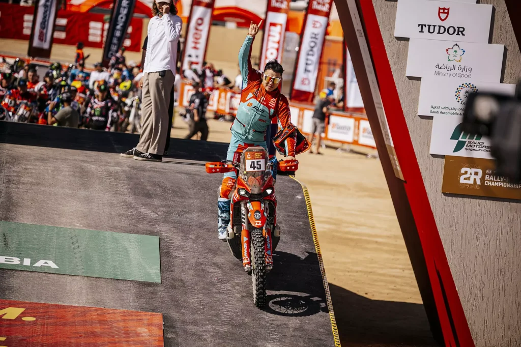 KOVE rider preparing at Dakar Rally 2026 start podium